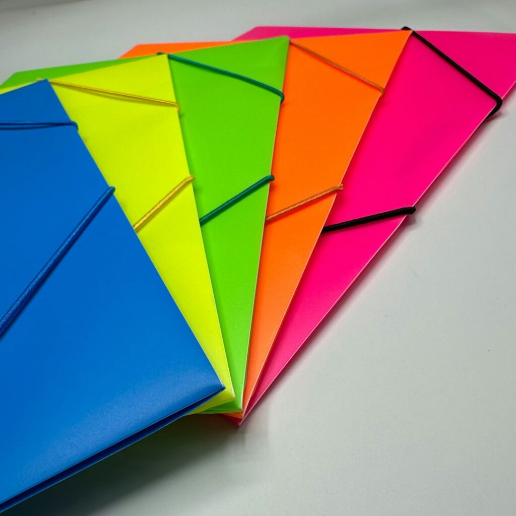 Photo by Wahid Khene a bunch of different colored papers on a table